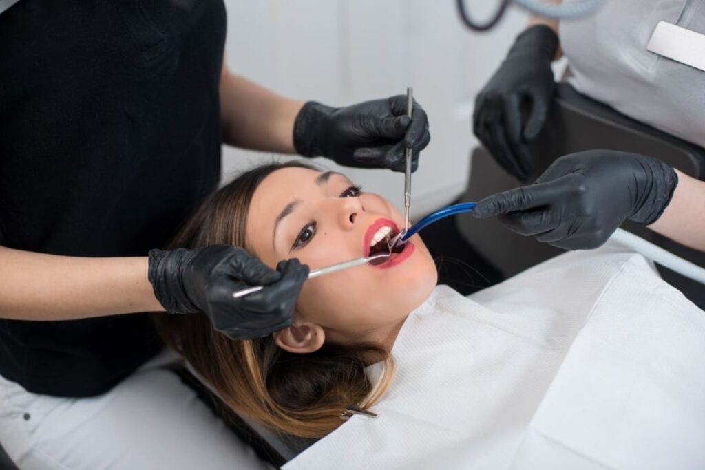Dentist examining patient's teeth during emergency dental treatment in Huntley.