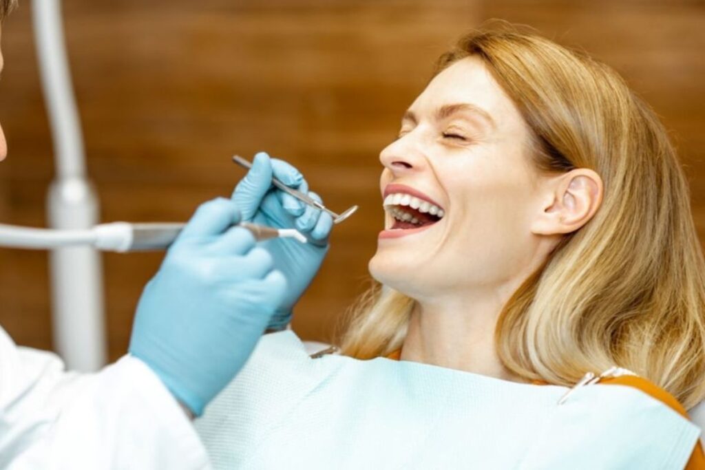 Happy patient receiving dental examination from dentist in Huntley.