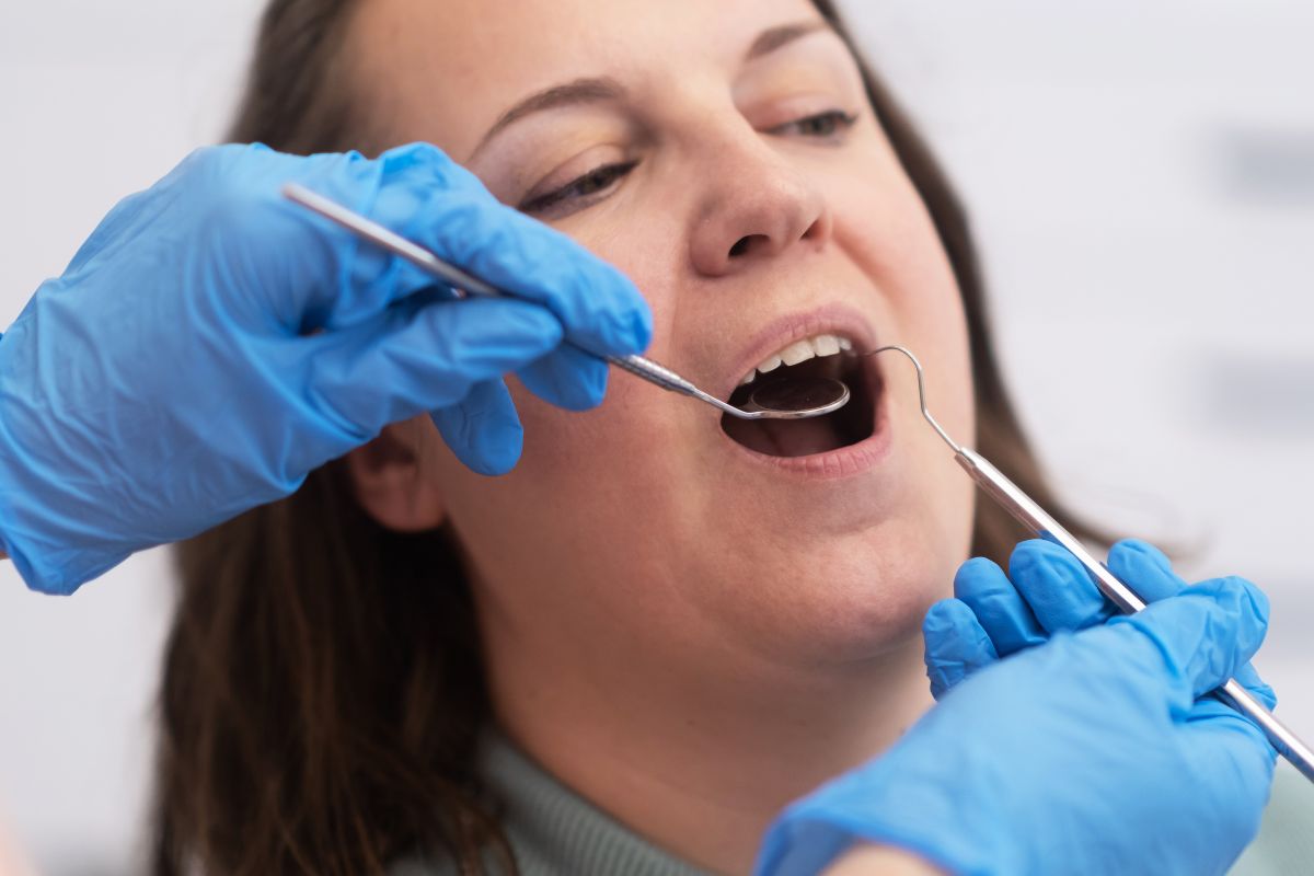 Female patient receiving a dental checkup from a dentist.