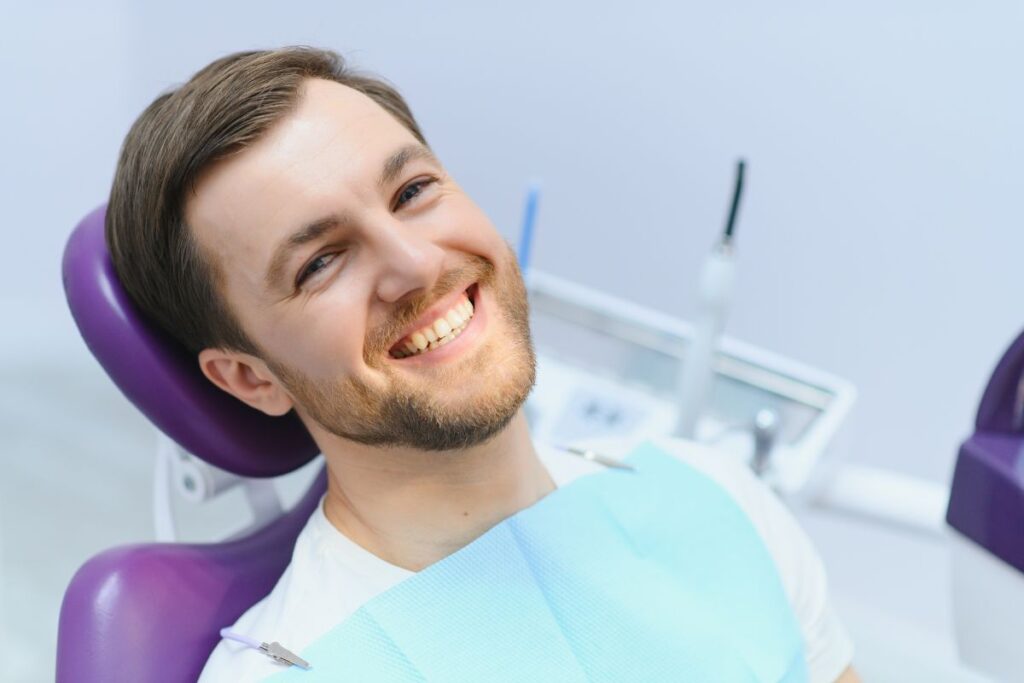 A patient smiling after a smile makeover treatment by a Cosmetic Dentist in Huntley.