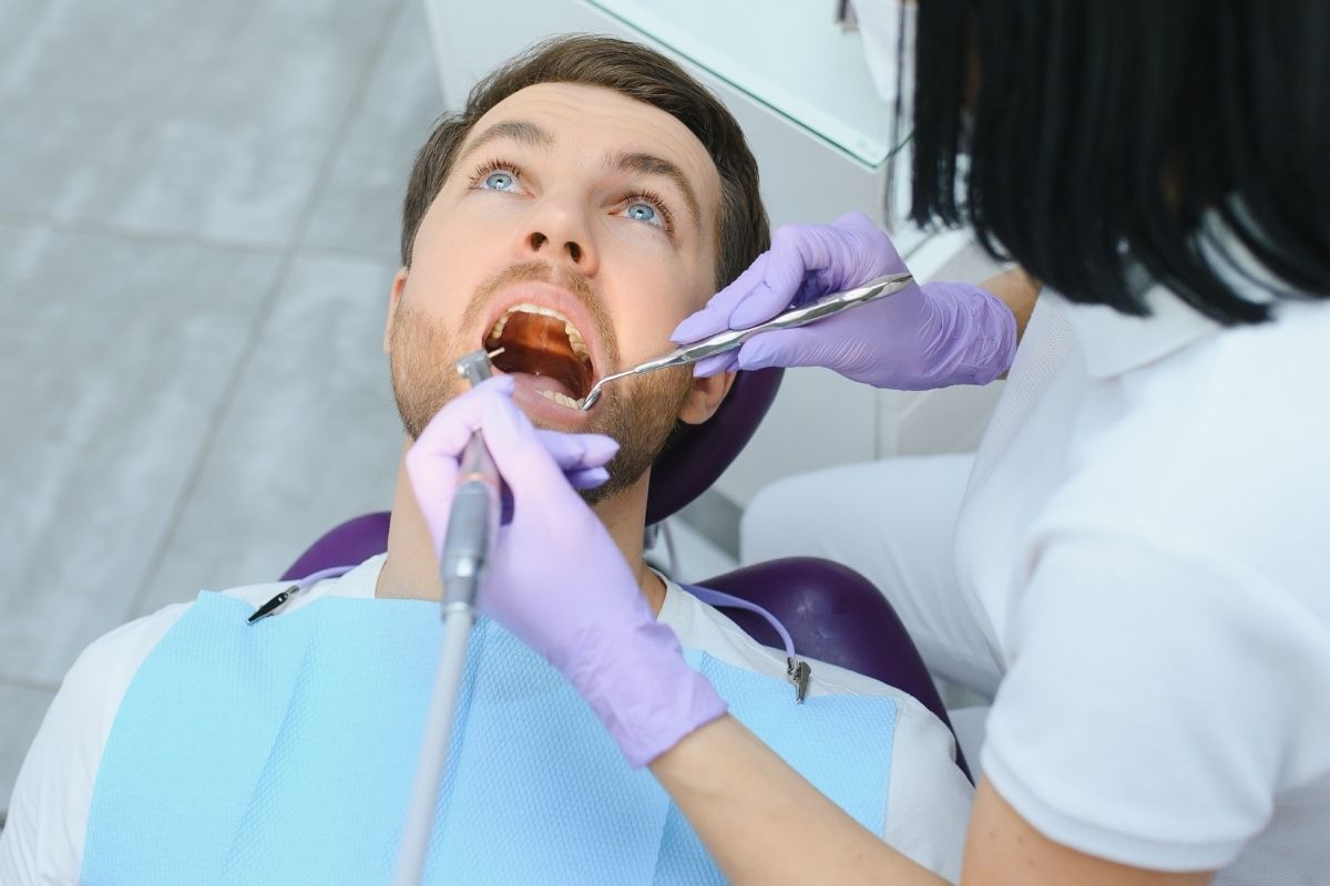 A patient receiving urgent care from an emergency dentist during a dental emergency.