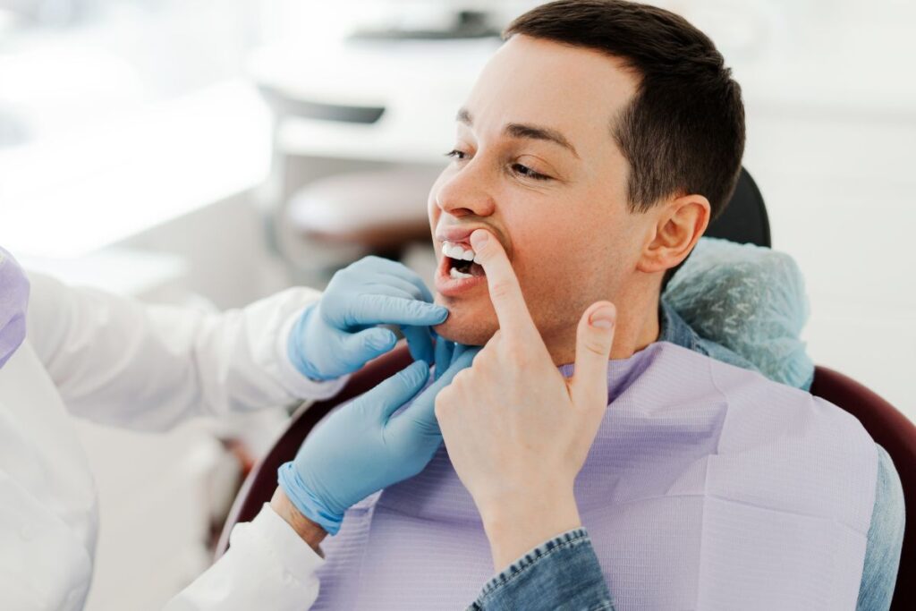 Dentist examining a patient’s teeth during a comfortable dental visit.