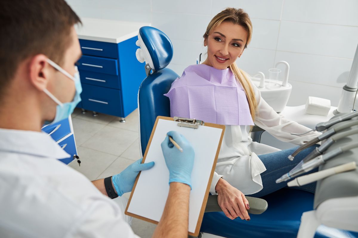 Patient discussing gum disease symptoms with a dentist.