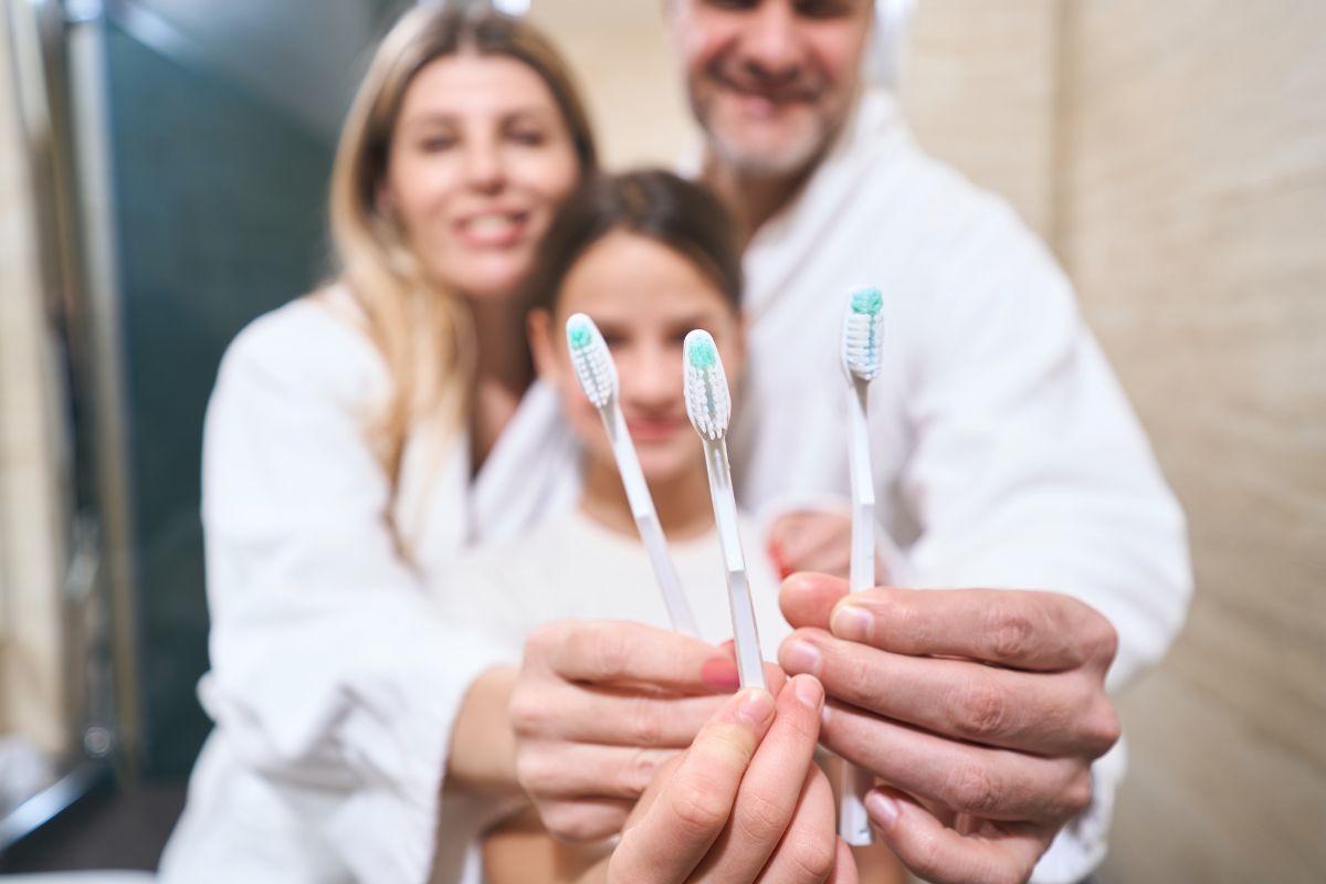 Family brushing together to build healthy oral care habits.