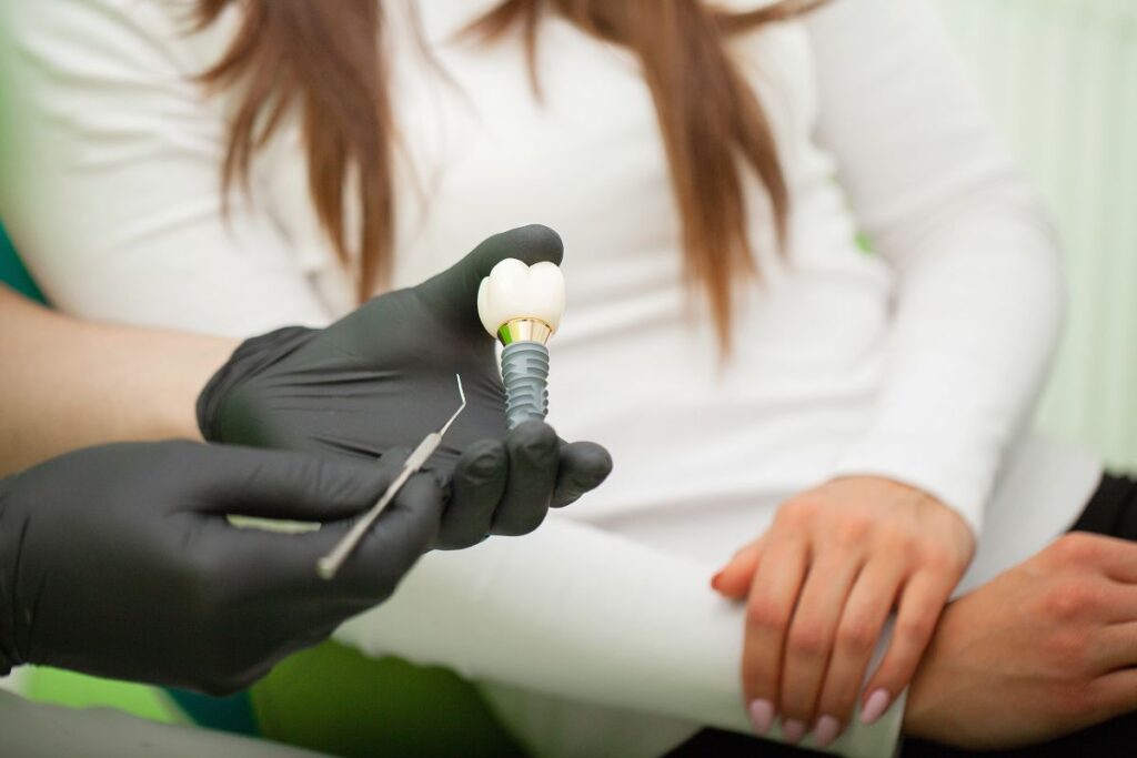 Dentist presenting a dental implant.